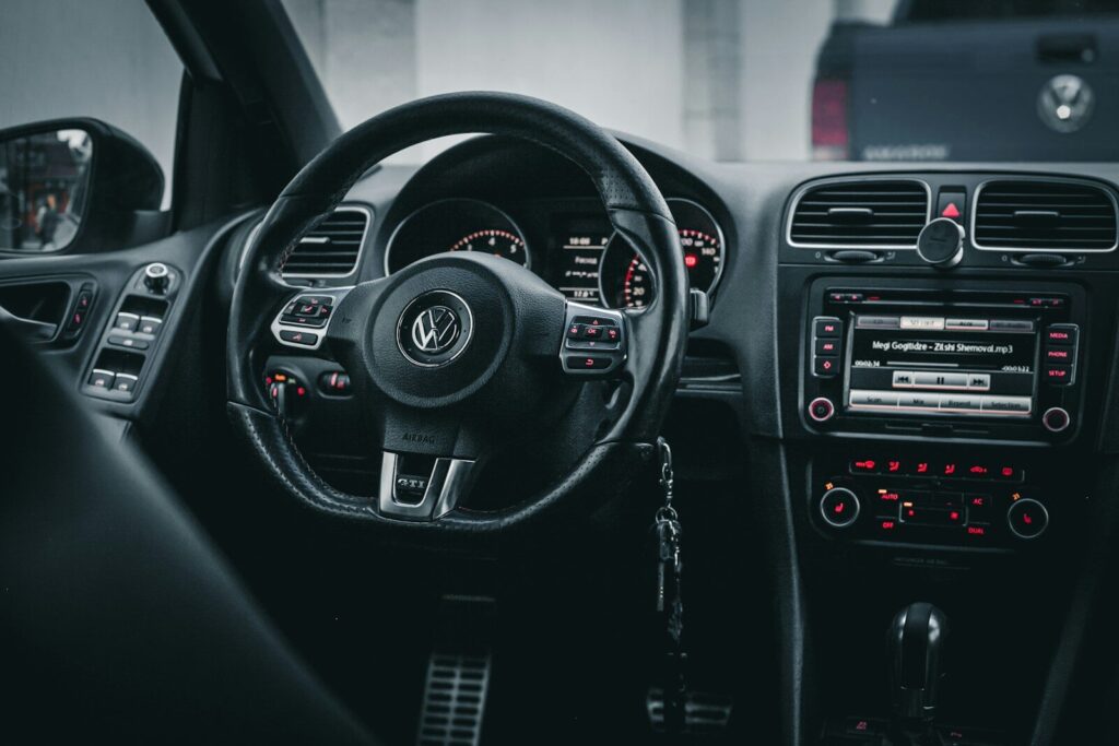 the interior of a car with a steering wheel and dashboard