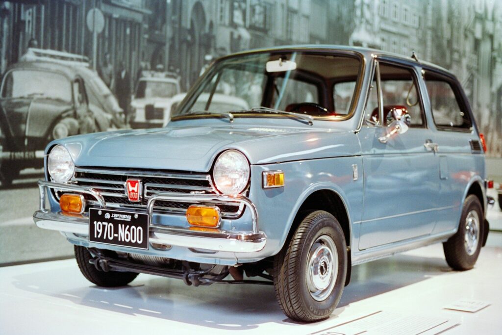 A light blue vintage honda n600 car on display