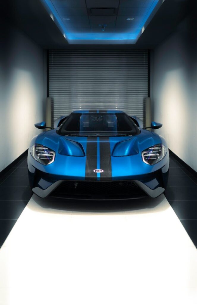 a blue sports car parked in a garage