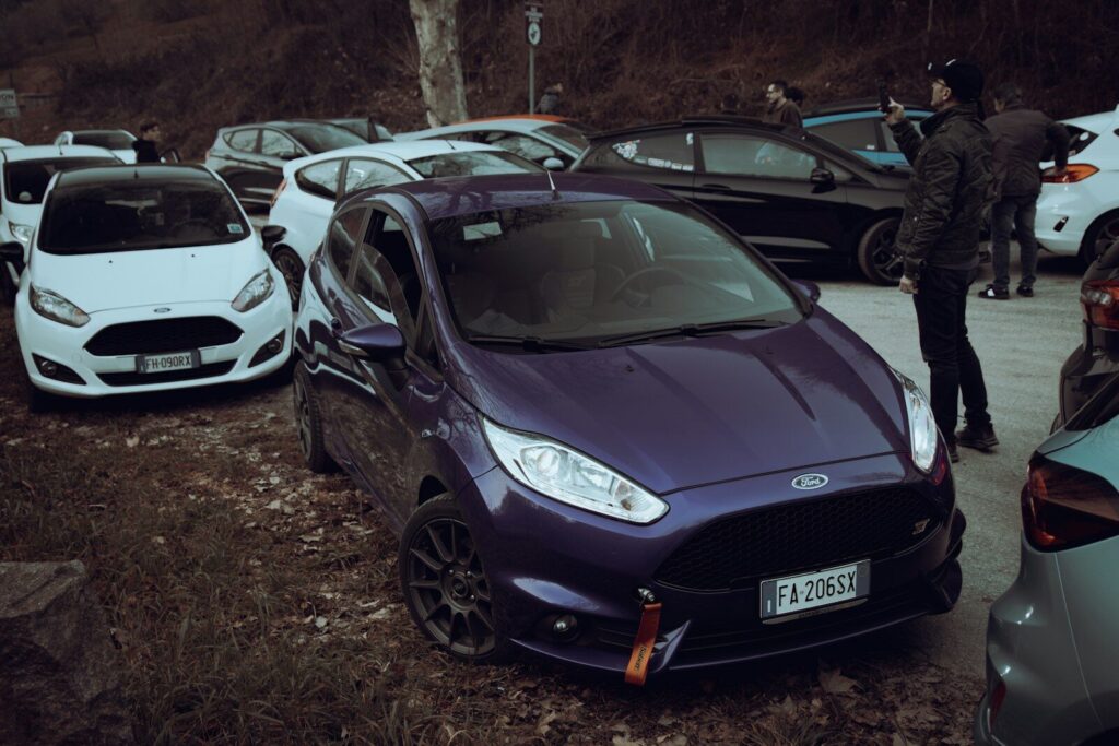 a group of cars parked next to each other in a parking lot