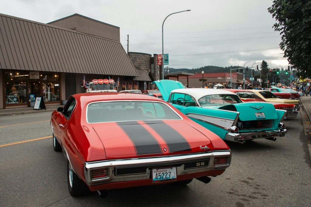 A row of classic cars parked in front of a building