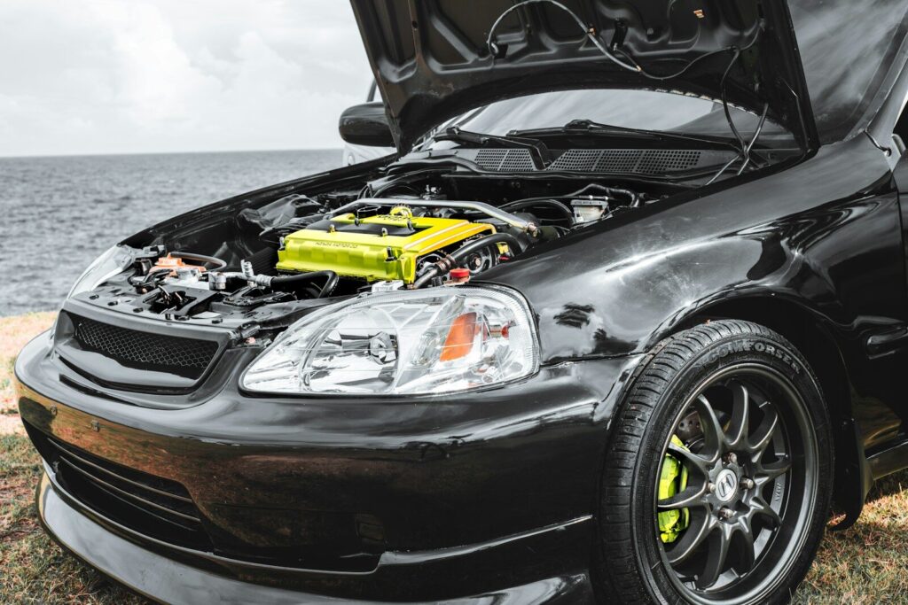 a car with its hood open and a yellow engine