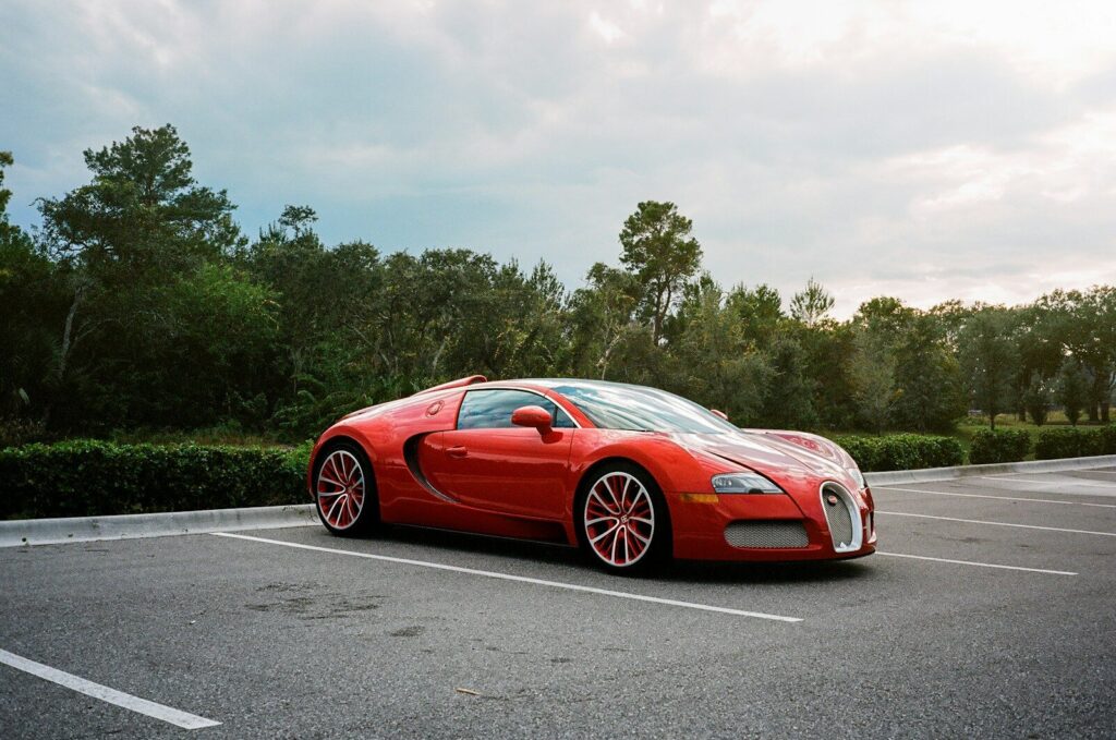 Red sports car parked in an empty lot