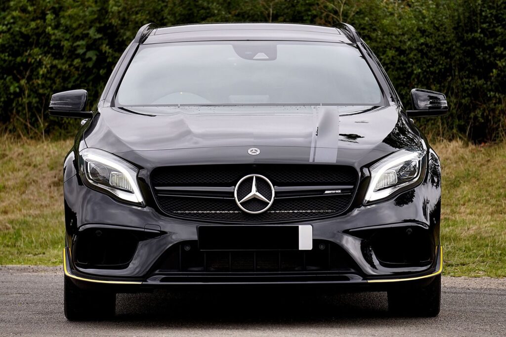 Luxurious black Mercedes-Benz AMG parked outdoors, showcasing elegance and style.