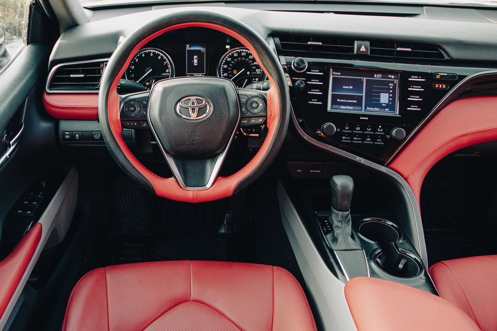 Explore the luxurious design features of a Toyota Camry with a bold red leather interior, showcasing its stylish dashboard.