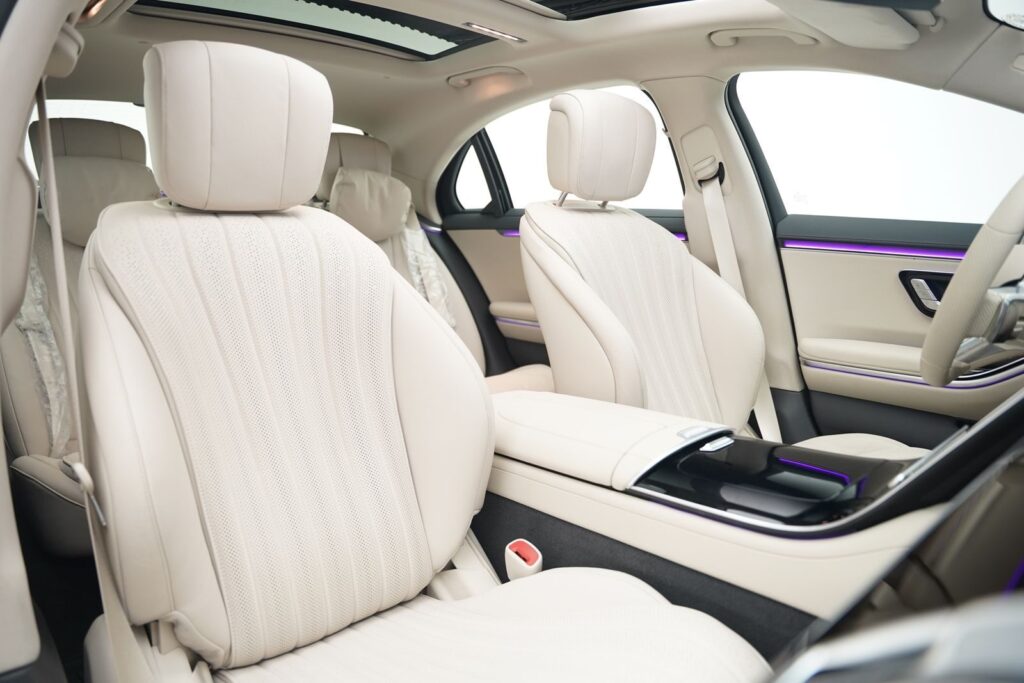 Explore the spacious and elegant white leather interior of a luxury vehicle.
