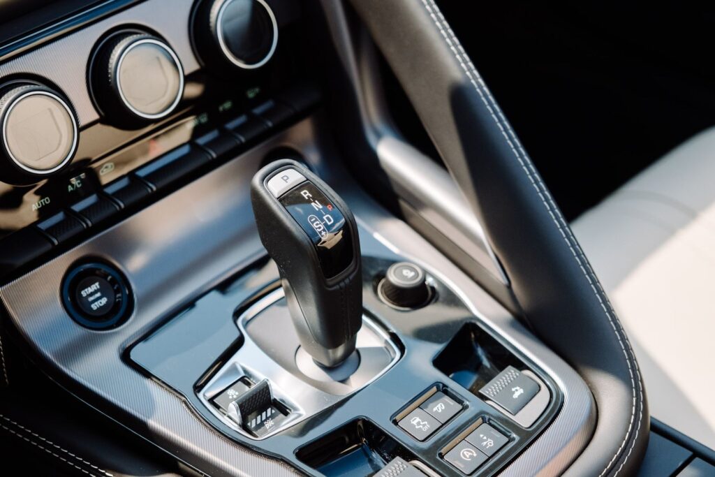 Detailed shot of a luxury sports car's gear shifter and control panel.
