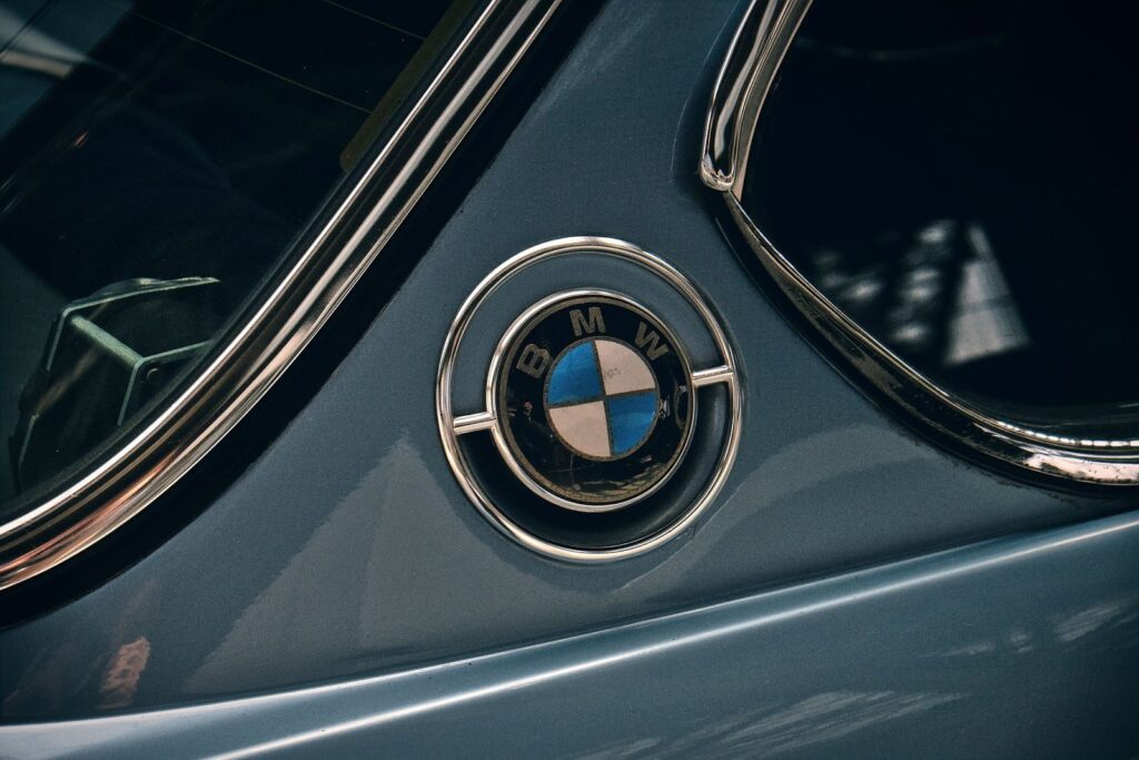 Close-up shot of a vintage BMW logo on a classic car. Iconic automotive detail.
