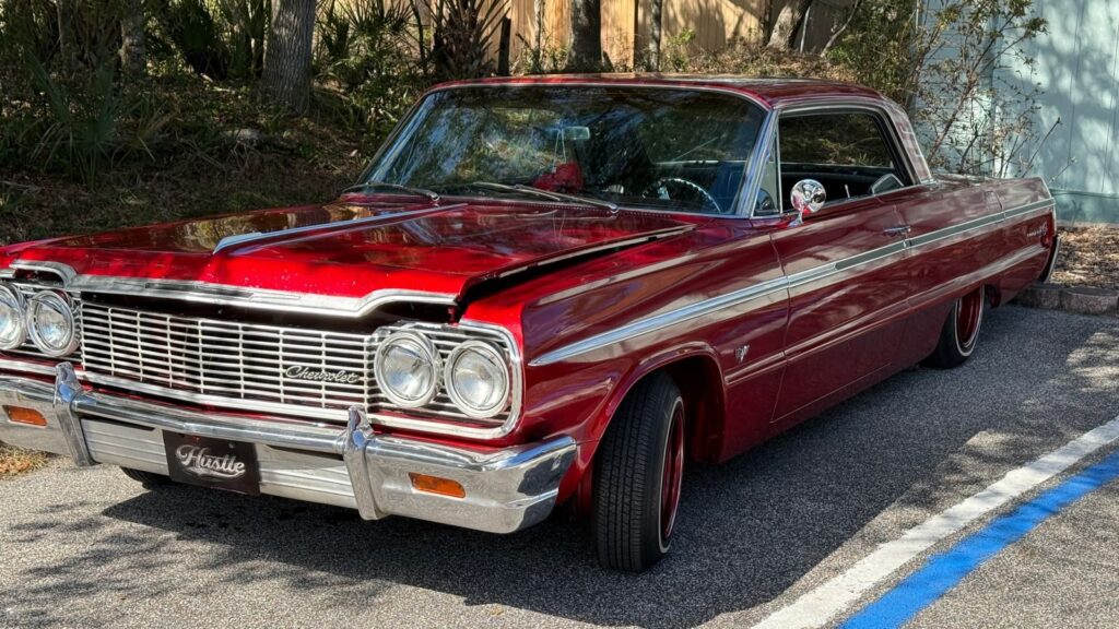 A stunning red Chevrolet Impala parked outside, showcasing vintage elegance.