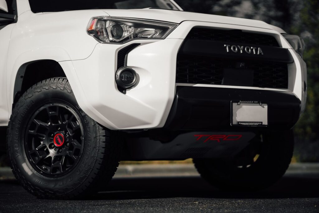 Detailed shot of a white SUV front bumper and tire for rugged adventures.