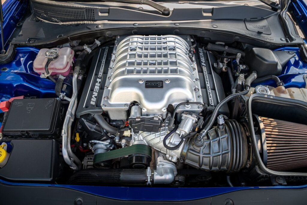 Detailed view of a powerful supercharged HEMI engine in a modern vehicle.