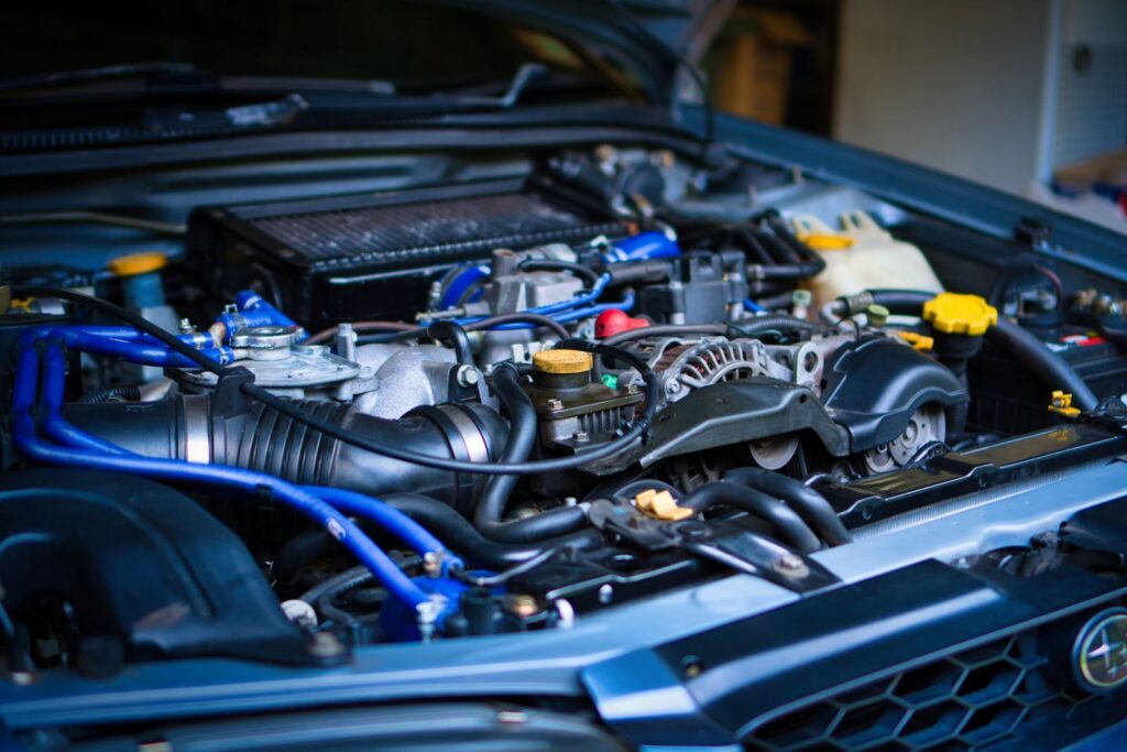 High-resolution image of a car engine with visible components in a garage setting.