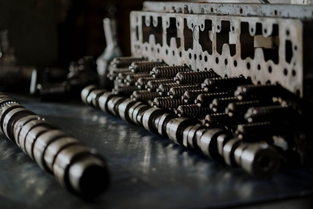 Detailed close-up of engine components including camshafts and springs on a workbench.