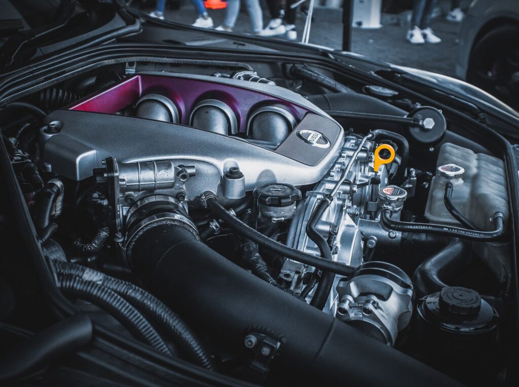 Detailed shot of a Nissan car engine bay featuring intricate engine parts and components.